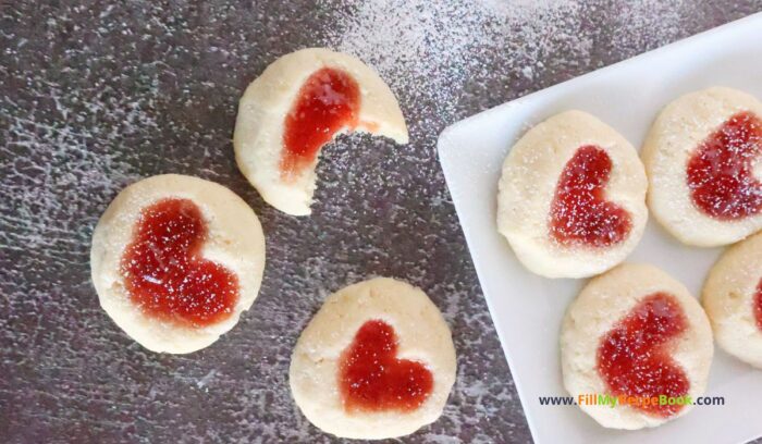 Strawberry Heart Thumbprint Cookies recipe. An easy dough mix idea and strawberry jam or puree filling for a snack at Christmas holidays.