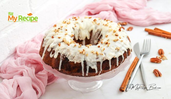 Once the cake is completely cooled, spread the Cream Cheese Frosting over the top, letting it drizzle down the sides, and sprinkle with chopped pecans.