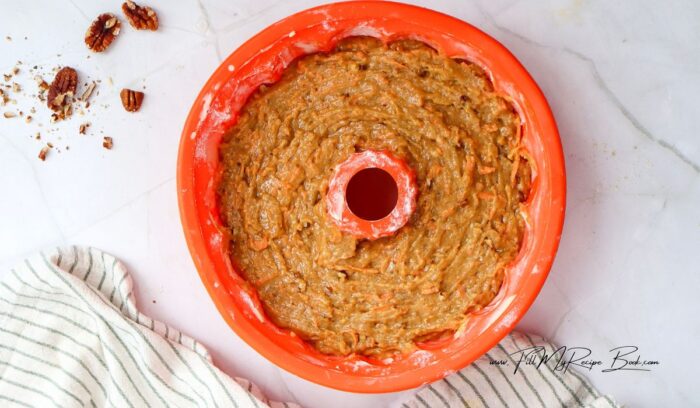 Pour into Bundt Pan. Pour the batter into the prepared Bundt pan, smoothing the top with a spatula.