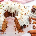 Carrot Bundt Cake with Maple Syrup recipe. A moist Oven bake dessert spiced with cinnamon and nutmeg, with nuts, frosted with cream cheese.