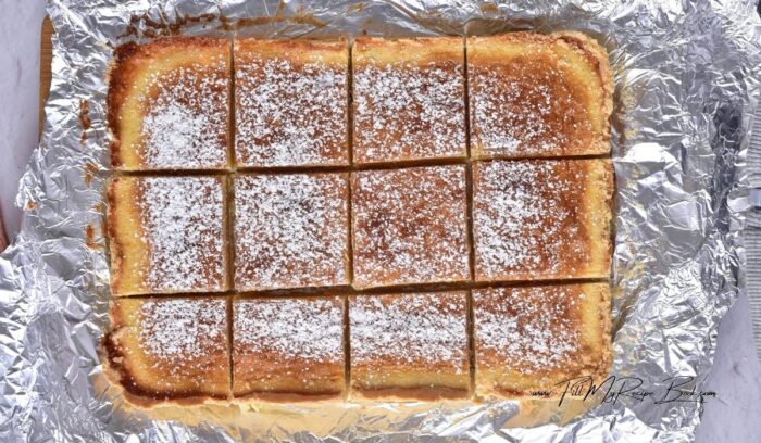 Remove the finished lemon bars from the oven and let cool for about 2 hours. After two hours, the lemon bars will become denser and easier to cut. Dust the lemon bars with powdered sugar and cut into squares or rectangular pieces.