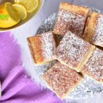 A Homemade Lemon Bars Recipe idea. Bake this buttery shortbread base with lemon zest and juice topping dusted with powdered sugar.