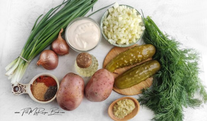 Ingredients for a Twice Baked Potato Salad. Smashed potato with pickled cucumbers dill and garlic baked twice baked potatoes for a salad side dish.